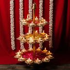 Gold Tierplated Diya Stand With Candles And Flower Decoration